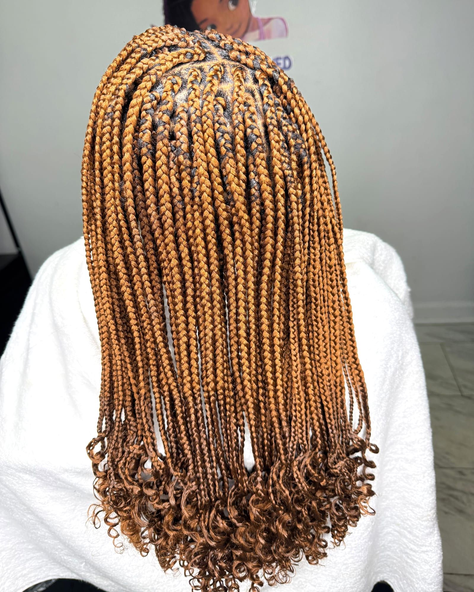 Honey-blonde knotless braids with curled ends