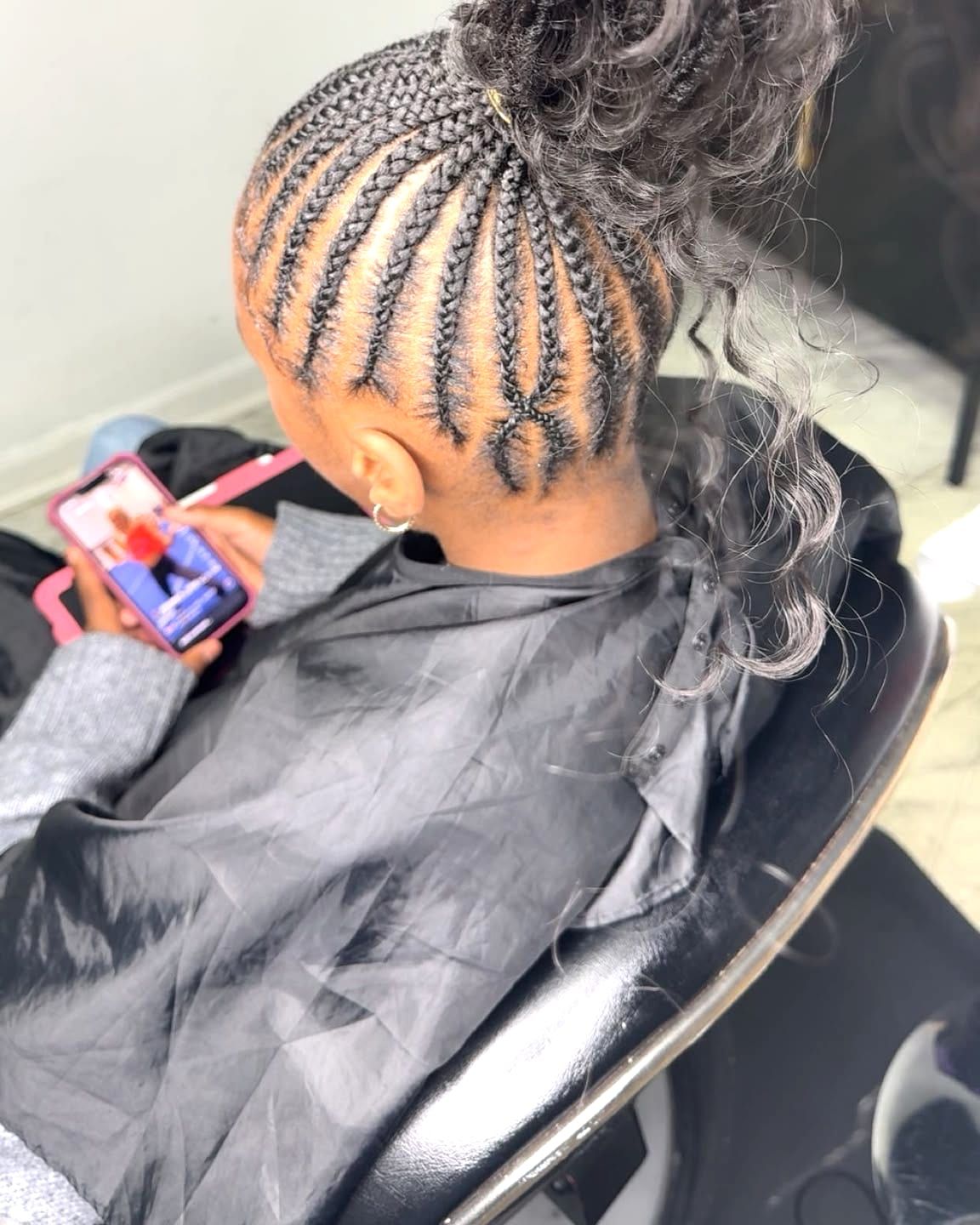 Cornrows swept into a high braided ponytail