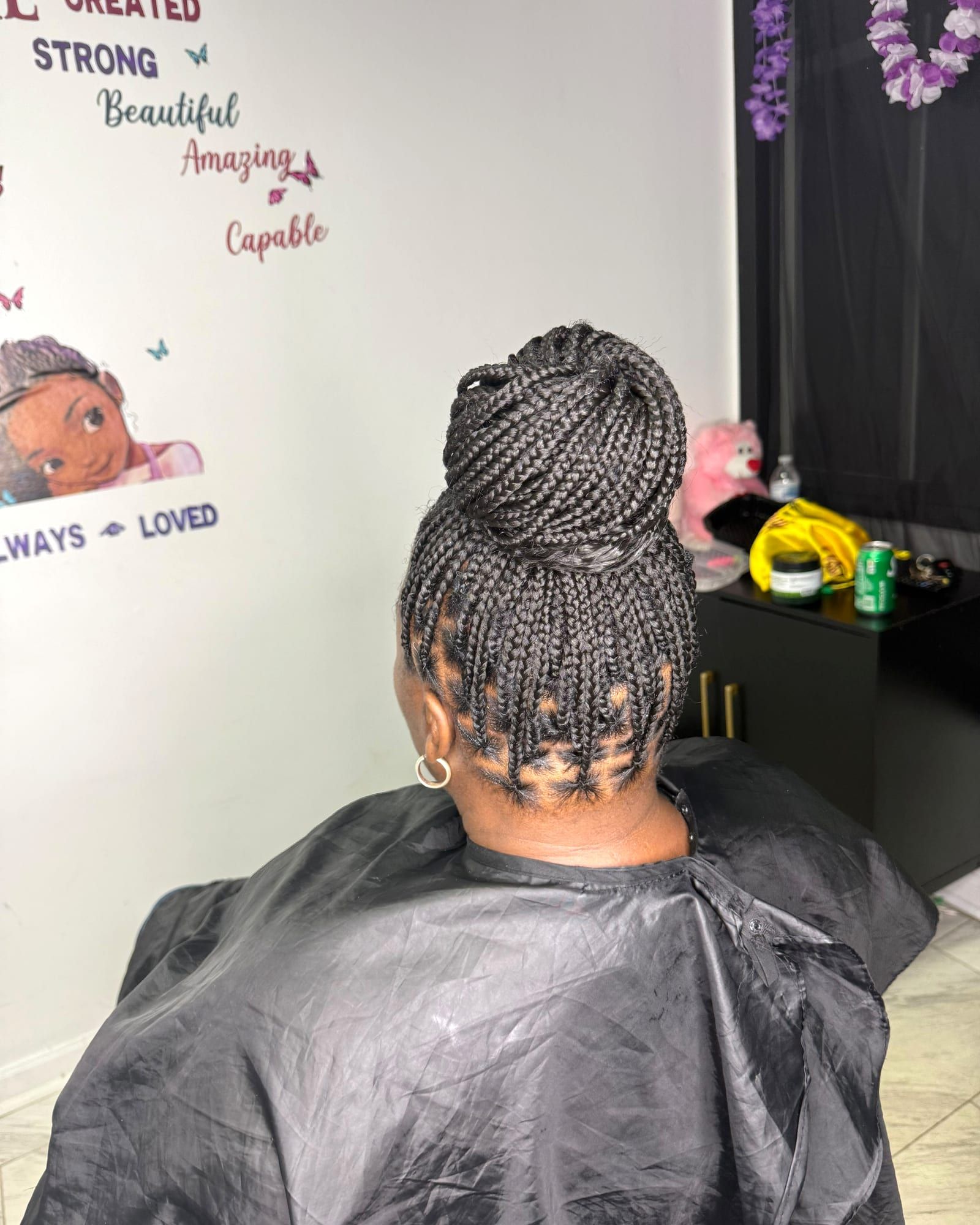 Box braids styled into a high bun