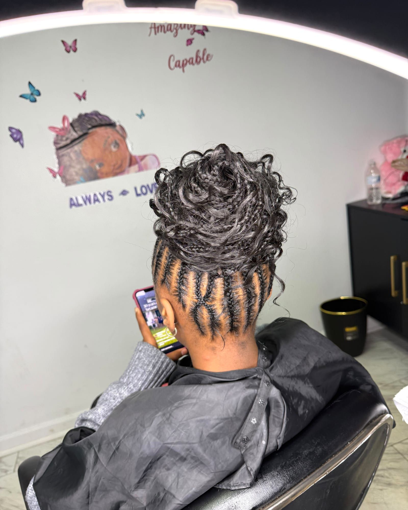 Cornrows finished with a curly bun